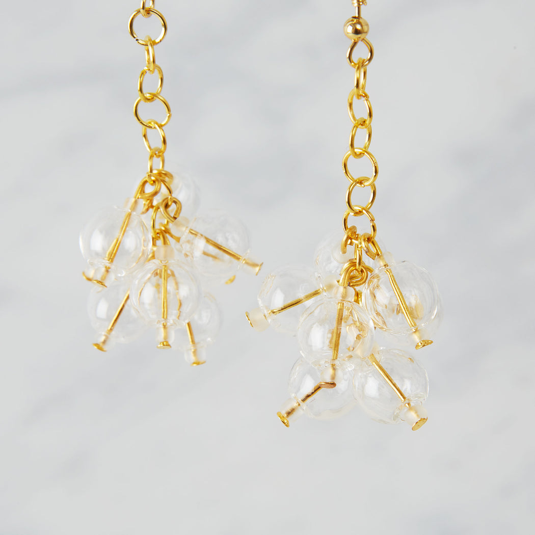 Brass earrings with nine glass beads in a bubble 