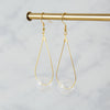 Brass earrings with a single clear glass bead 