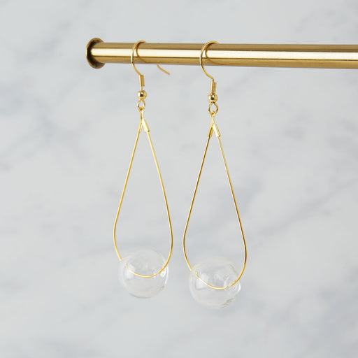 Brass earrings with a single clear glass bead 